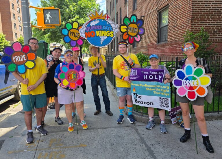 Queens Says No Kings participants gather with colorful Pride flowers and signs before the parade.